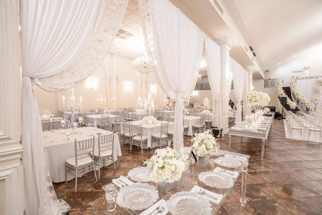 A large room with white tables and chairs