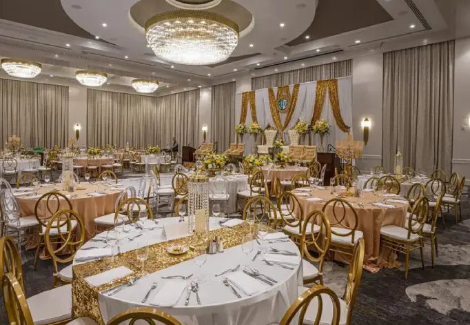 A banquet hall with tables and chairs set up for an event.