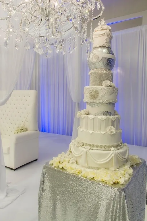 A large white wedding cake on top of a table.