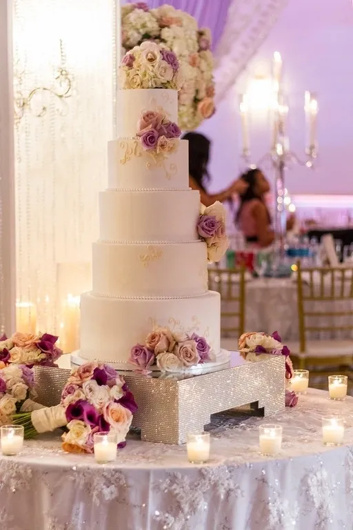 A wedding cake with flowers on top of it.