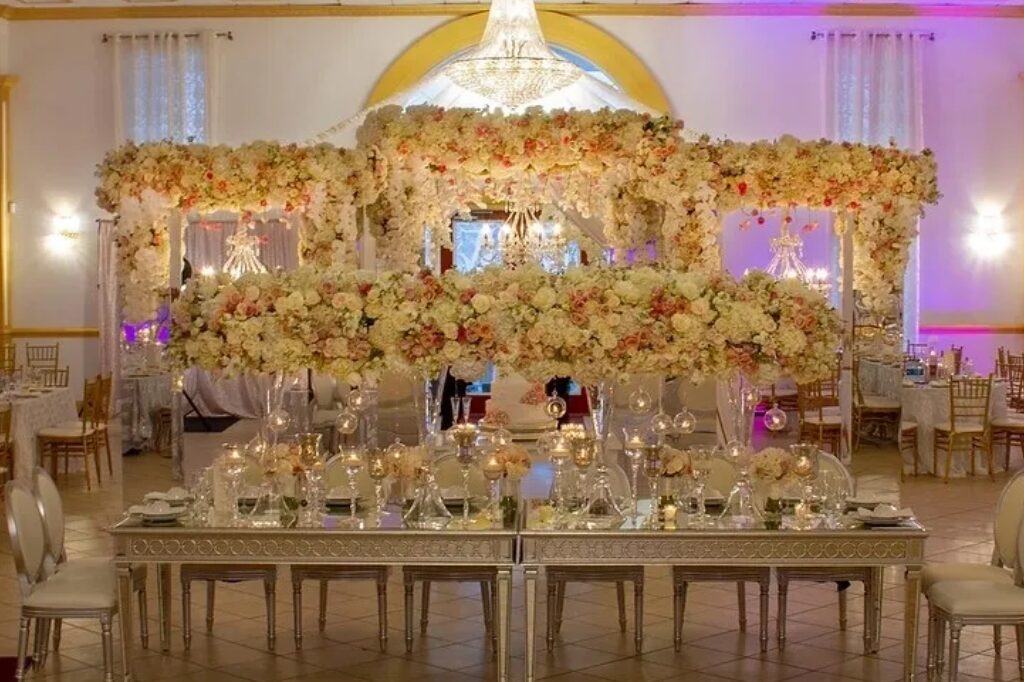 A large table with many chairs and flowers on it