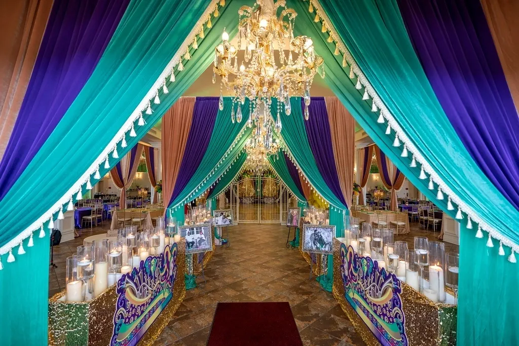 A long hallway with many colorful curtains and lights