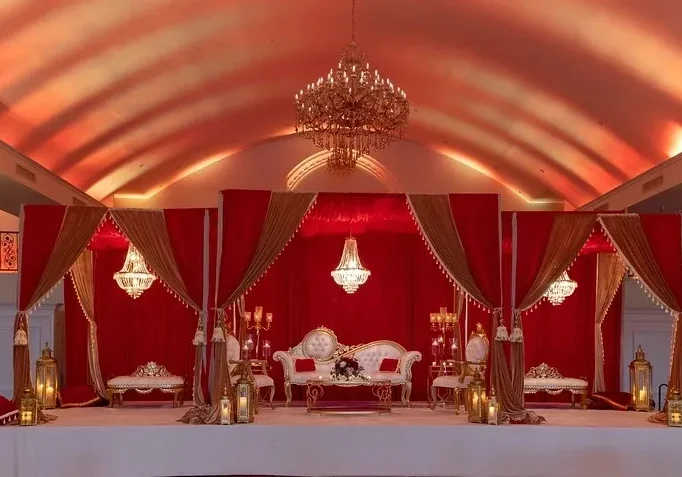 A red and white wedding tent with chandeliers